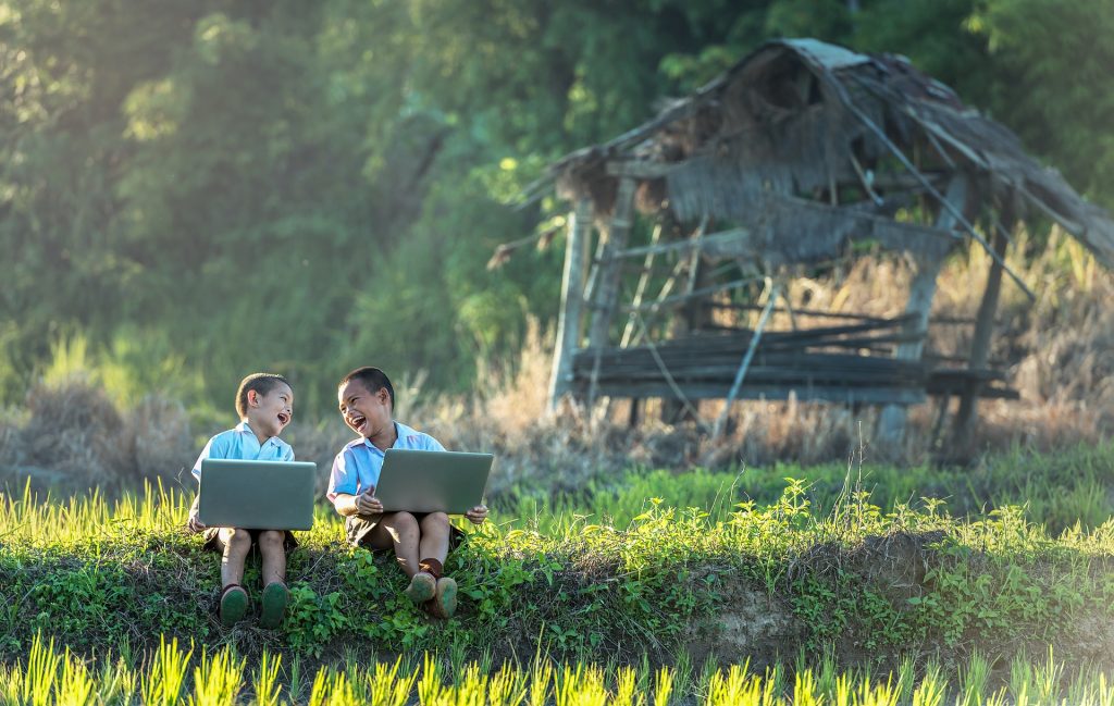 Kids Using Laptop On Field
