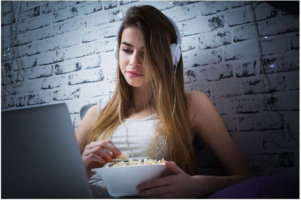 Girl using laptop and headphones