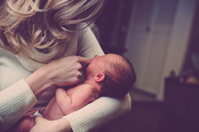 Crying baby with mum