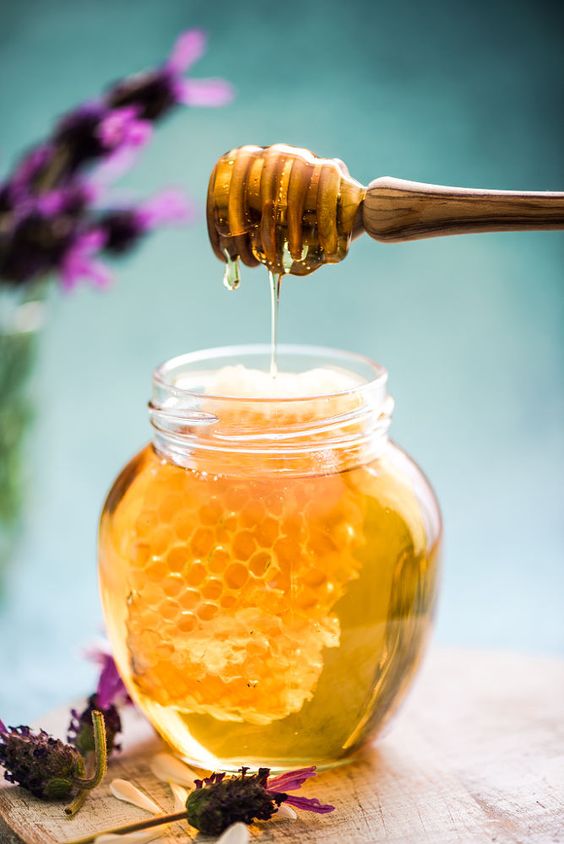 Honey dripping in jar