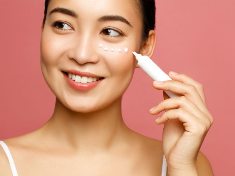 woman applying eye cream on undereyes
