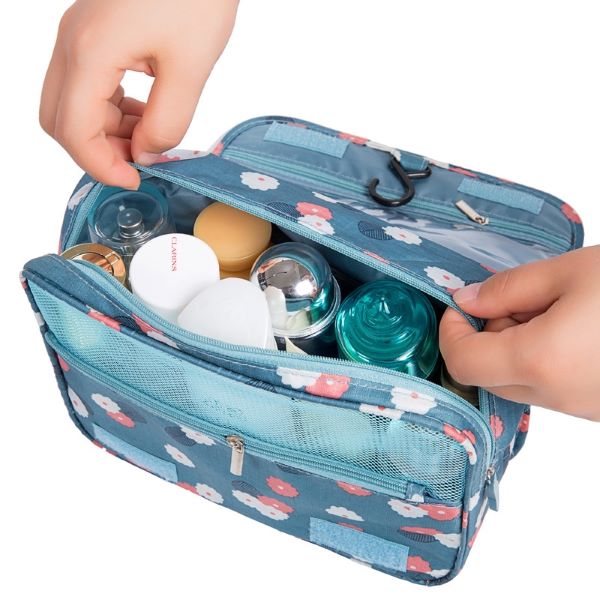 person opening blue toiletries bag