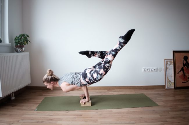 woman yoga mat green blocks props