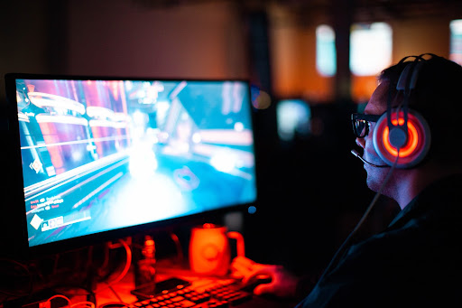 man with gaming headset playing computer game