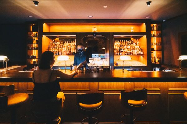 lady sitting at speakeasy bar at Cabinet 8 by JWC 