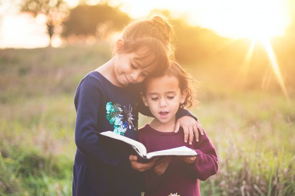 best children's book storybooks for kids two girls reading hugging