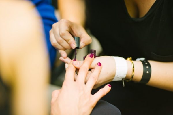 manicurist painting nails polish