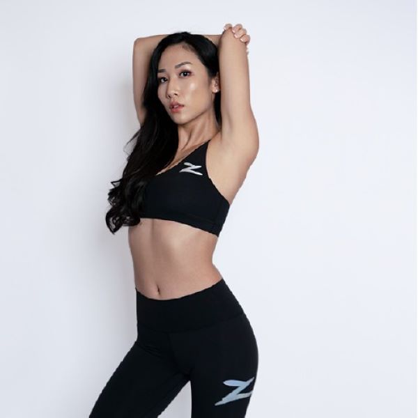 person wearing zouk x kydra collaboration sports bra and leggings in black