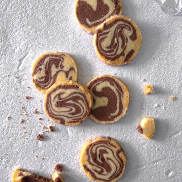 vanilla cookies with chocolate swirls on parchment paper