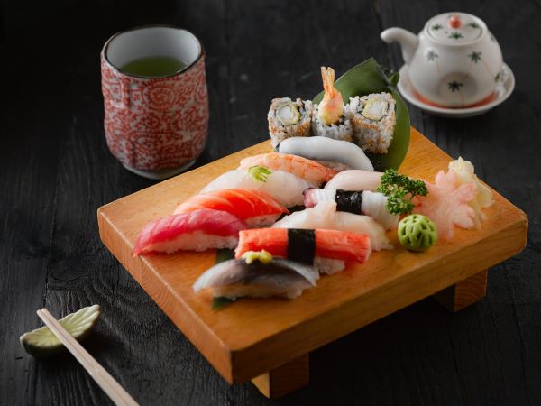 assorted sushi on wooden plate