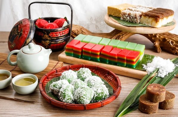 spread of colourful nonya kueh such as kueh lapis and ondeh ondeh