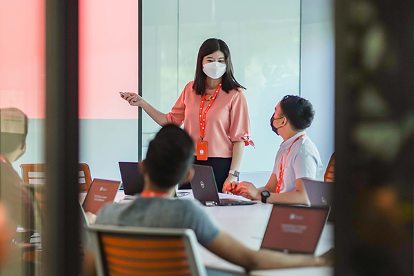 Clara leading a meeting with her team members