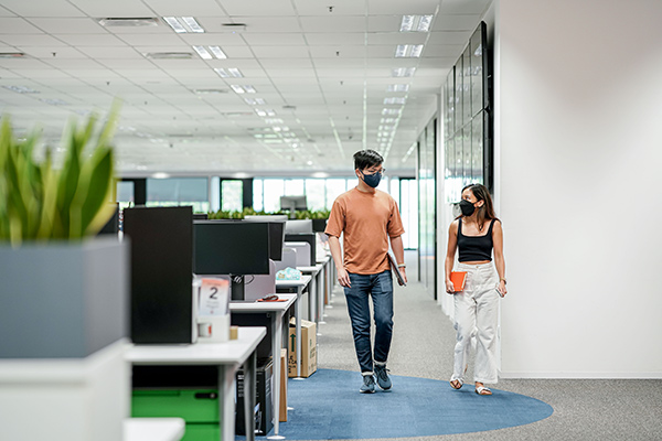 Two Shopee employees walking in the office