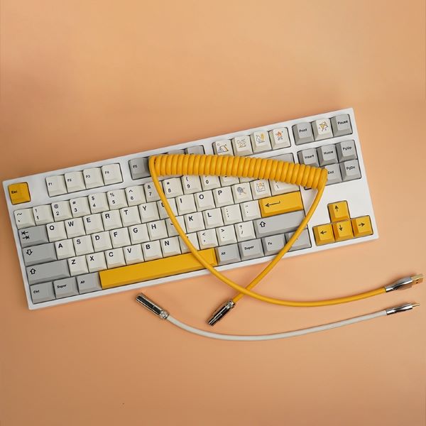 yellow aviator cable on top of a mechanical keyboard