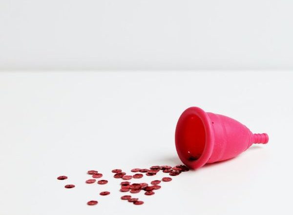 red menstrual cup with white background