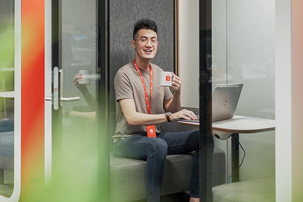 Ryan enjoying a cup of coffee in one of Shopee’s phone booths Shopee Engineer