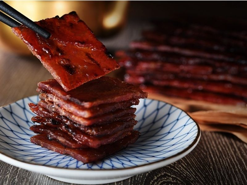 slices of bak kwa squares on a plate