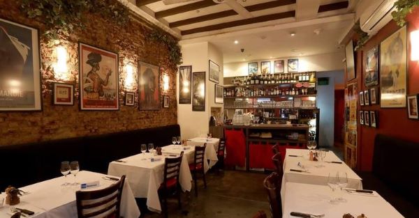les bouchons interior design with white tables and red walls best french restaurant singapore