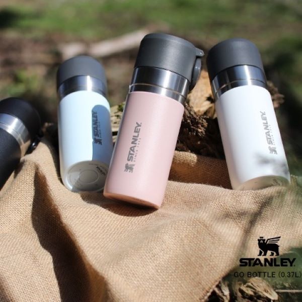 stanley go mini vacuum bottles in pink, and white in the outdoors