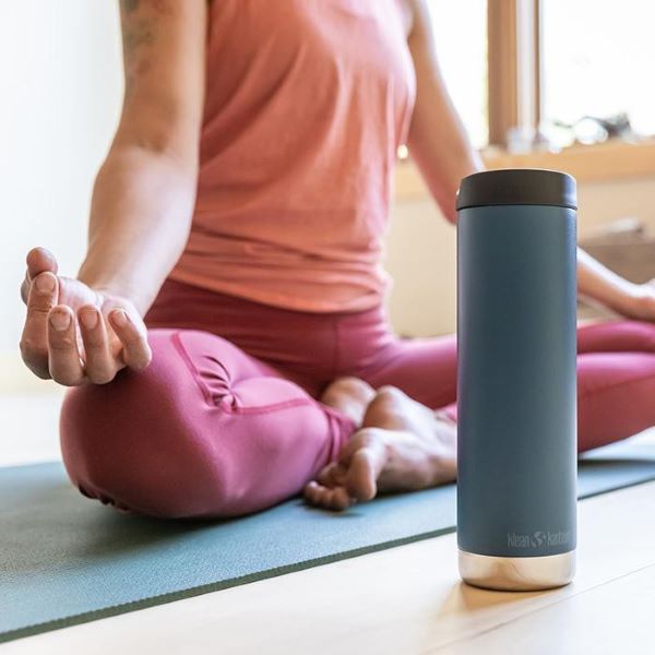 lady in pink clothes doing yoga next to a blue klean kanteen water bottle best water bottle singapore
