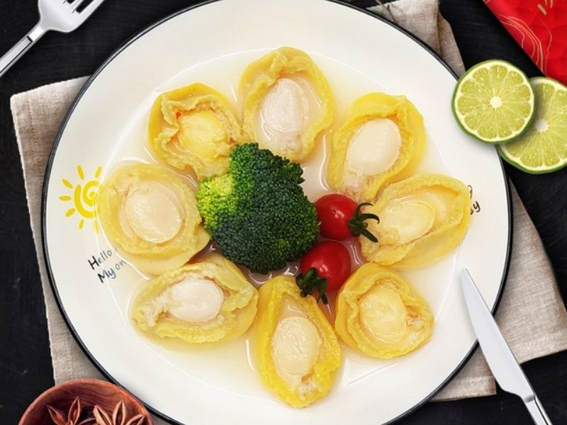 plate of abalones with broccoli and cherry tomatoes in the center