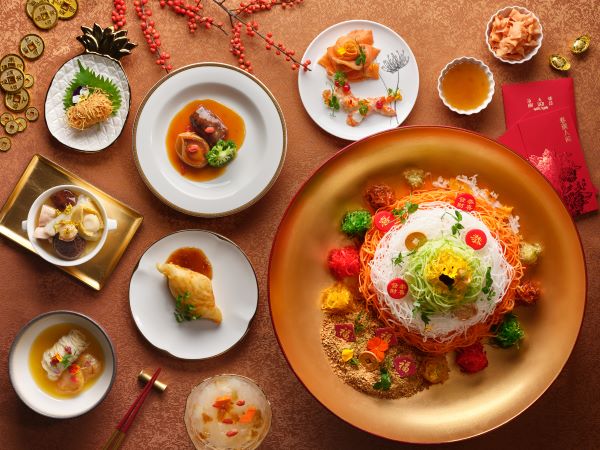 spread of dishes including yusheng 