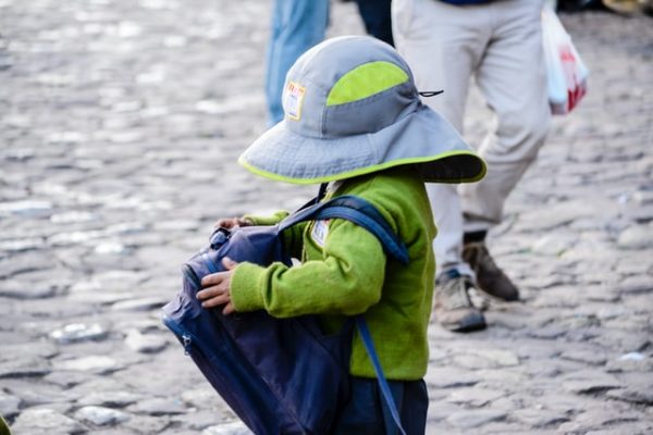 boy green jacket hat school bag backpack