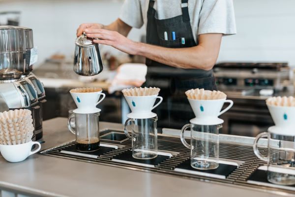 barista brewing cover using pour over method