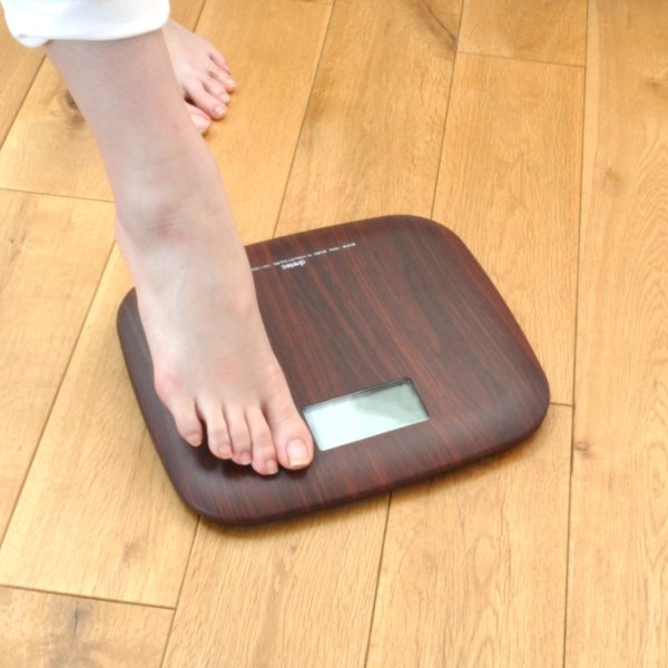 stepping on weighing scale wood grain design