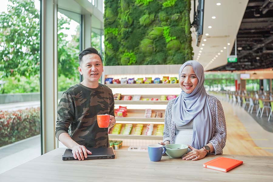 Allan (left) and Mardhiyyah (right) catching up over breakfast before the start of the work day