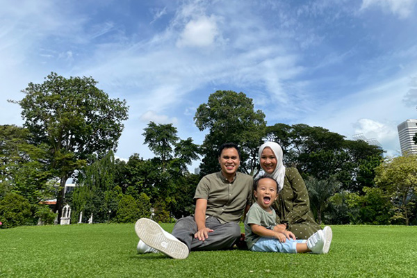 Mardhi smiling for the camera with her son and husband