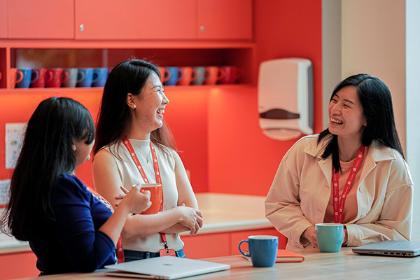 The three ladies enjoying a conversation over a coffee break