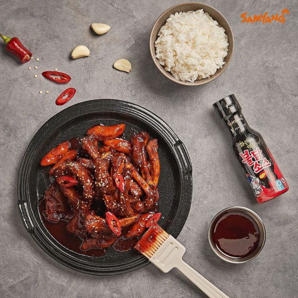 flatlay of samyang buldak sauce and a plate of tteokbokki and a bowl of rice