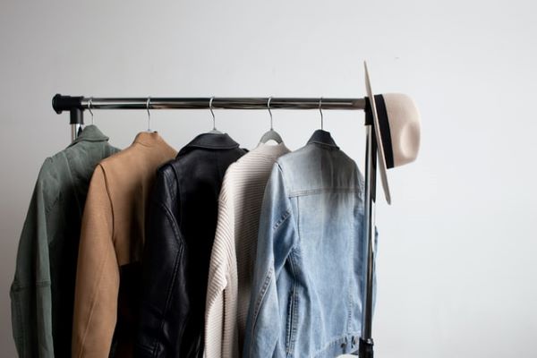 open clothes rack with outerwears such as denim and leather jacket