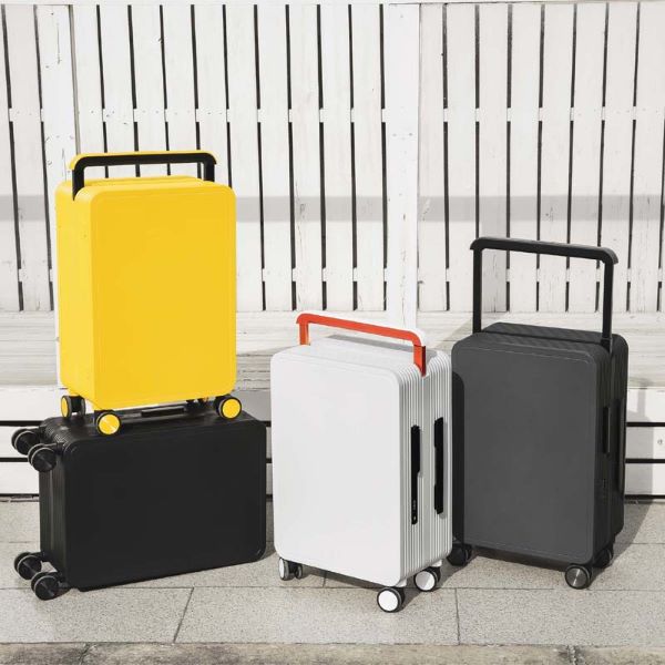 black, white, and yellow luggage