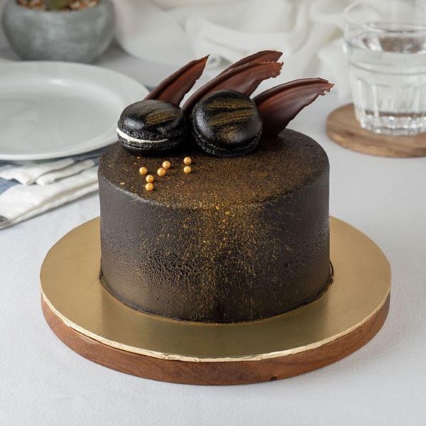chocolate ganache cake with gold sprinkles and macaron toppings best durian cake singapore 2022