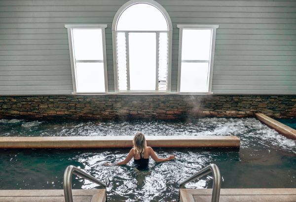 woman soaking in pool at deep blue hot springs