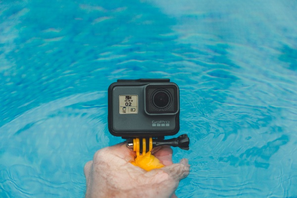man holding action camera in water best action cameras