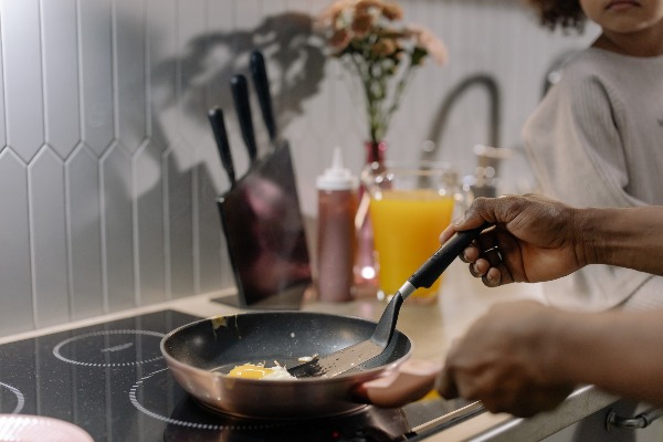 woman frying egg best induction cooker singapore
