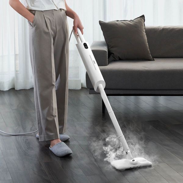 man cleaning wooden floor with a steam mop