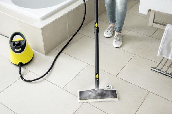 person using karcher steam cleaner on tiled flooring