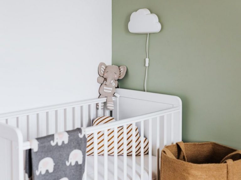 baby crib with cloud hanging lights and soft toys