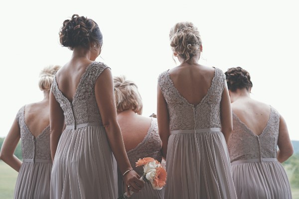 back view of bridesmaids holding bouquets