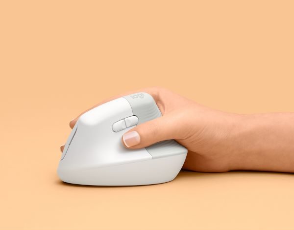 person holding white logitech ergonomic mouse against orange background