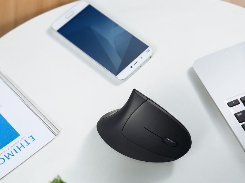 black ergonomic mouse on a white desk