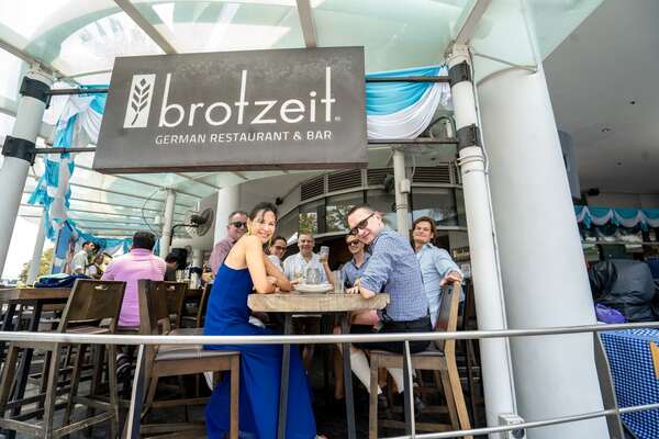 customers at brotzeit vivo city posing for a photo best sports bars singapore 2022