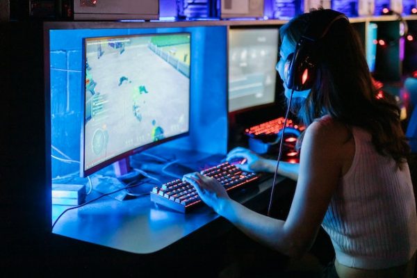 girl playing video game on ultrawide curved monitor