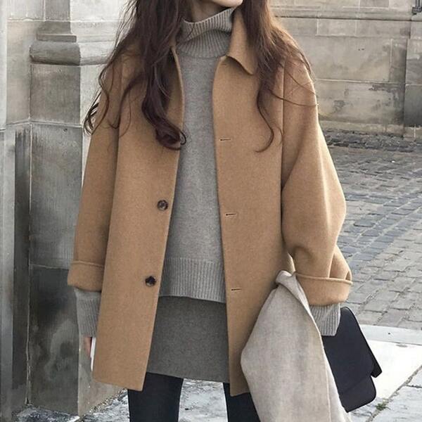 lady wearing beige wool coat winter packing list
