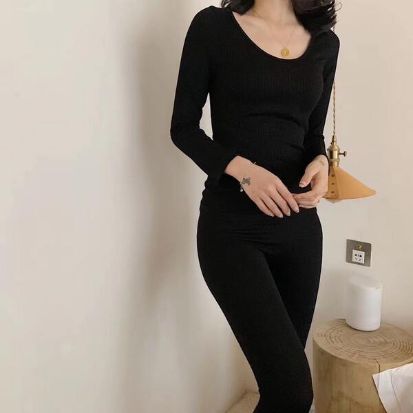 woman wearing black long johns thermal wear winter packing list
