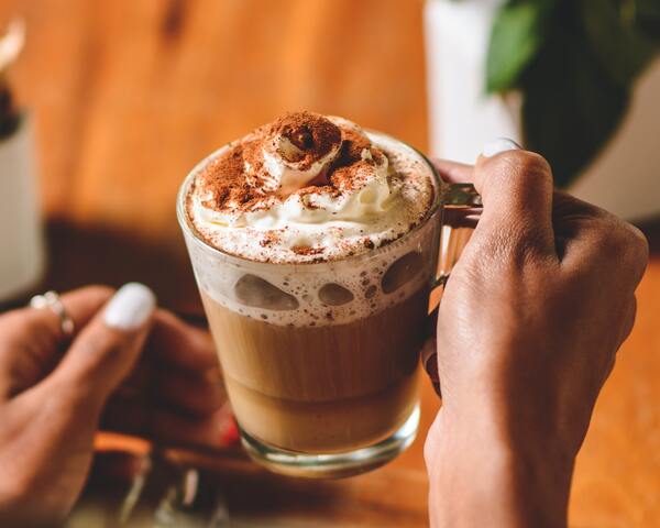 Person holding mug with the best instant hot chocolate powder in Singapore